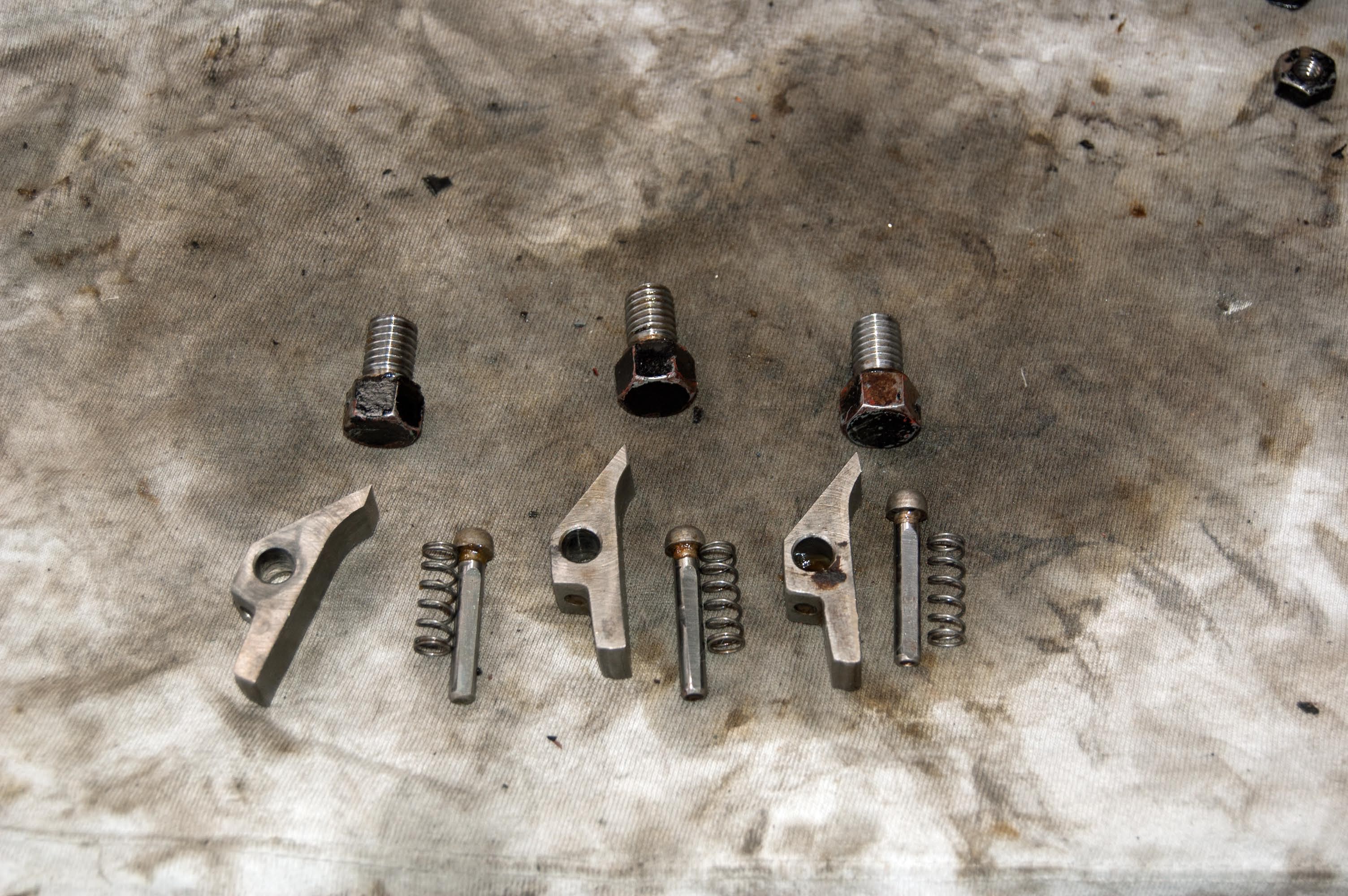 The three pawls, and associated parts, from one of the lubricator ratchets