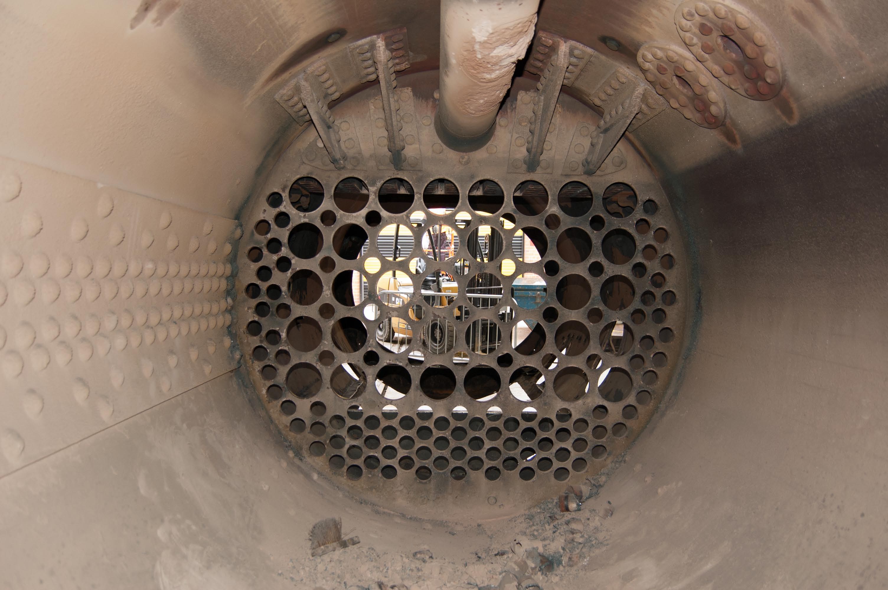 The front tubeplate, seen from inside the boiler barrel. The main steampipe is at the top, and the clacks are on the right. You can see the normal water level from the tide mark.