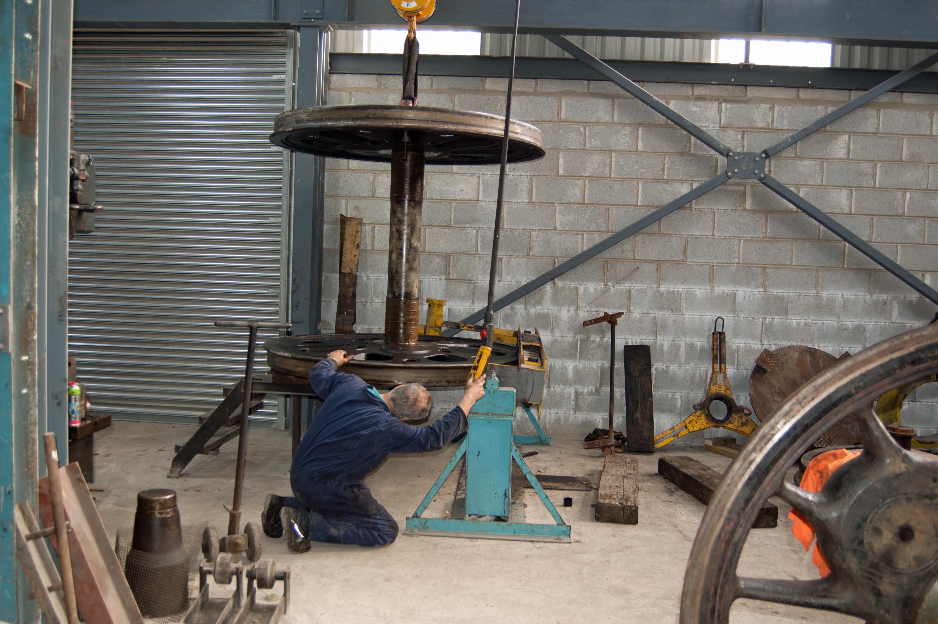 The wheelset is carefully tipped on end, before it is moved to the hearth