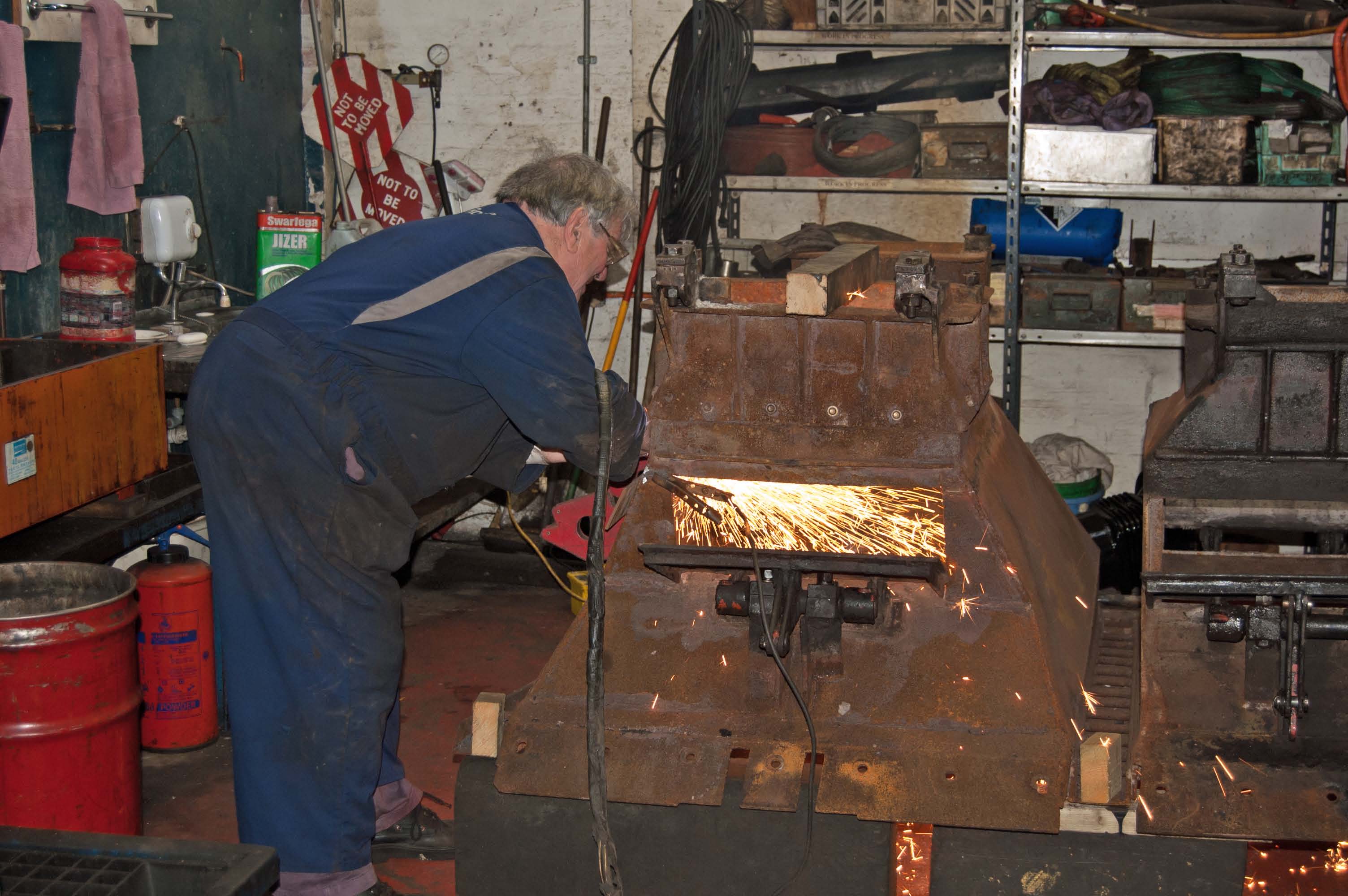 The plasma cutter is being used to remove damaged parts of the ashpans, so that they can be replaced or repaired.