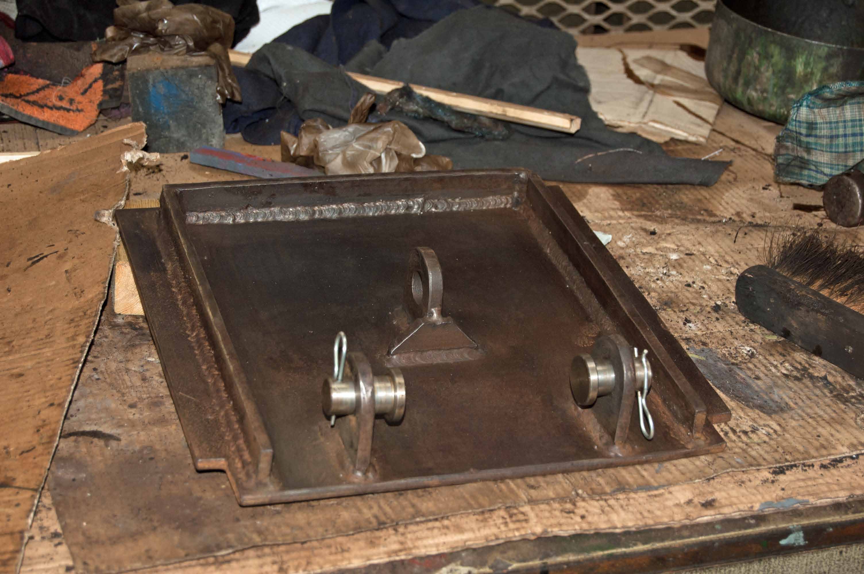 Every small part of the ashpans, including the damper and hopper door operating mechanisms, have to be cleaned before they can be painted. This is a damper door.